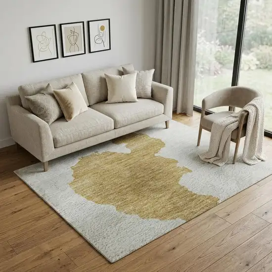 Gold And Ivory Abstract Washable Area Rug With UV Protection Photo 1