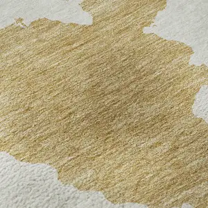 Photo of Gold And Ivory Abstract Washable Area Rug With UV Protection