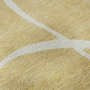 Photo of Gold And Ivory Abstract Washable Area Rug With UV Protection
