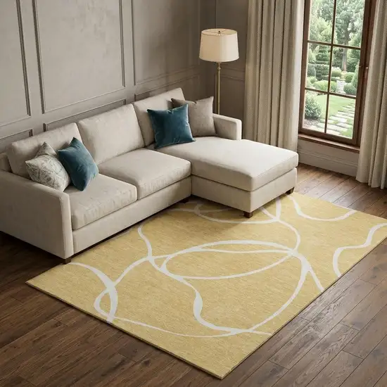 Gold And Ivory Abstract Washable Area Rug With UV Protection Photo 1