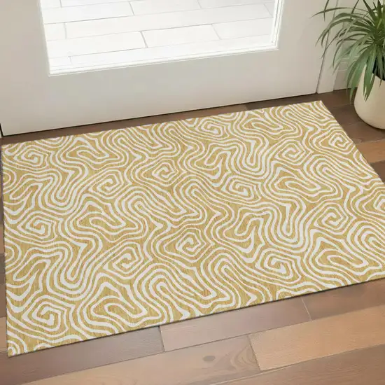 Gold And Ivory Abstract Washable Area Rug With UV Protection Photo 1