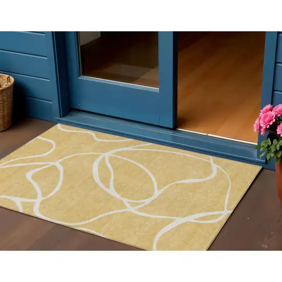 Gold And Ivory Abstract Washable Indoor Outdoor Area Rug Photo 1