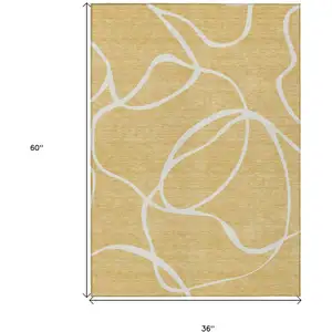 Photo of Gold And Ivory Abstract Washable Indoor Outdoor Area Rug