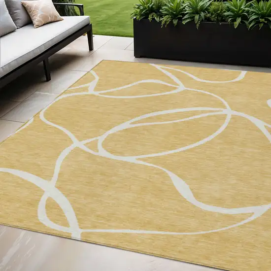 Gold And Ivory Abstract Washable Indoor Outdoor Area Rug Photo 1