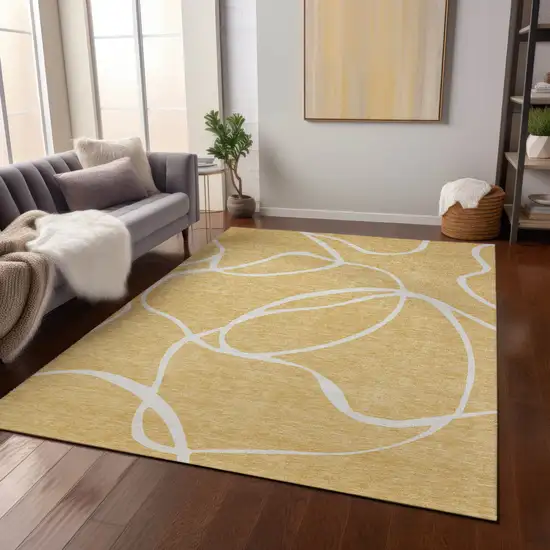 Gold And Ivory Abstract Washable Indoor Outdoor Area Rug Photo 9