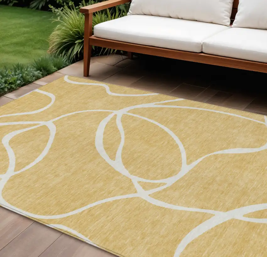 Gold And Ivory Abstract Washable Indoor Outdoor Area Rug Photo 1