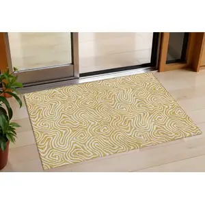 Photo of Gold And Ivory Abstract Washable Indoor Outdoor Area Rug