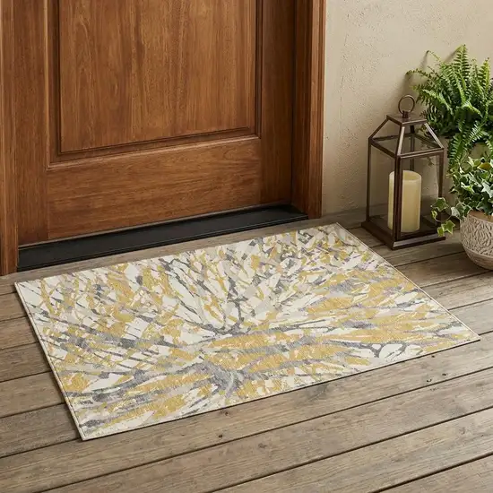 Gold And Ivory Abstract Washable Indoor Outdoor Area Rug Photo 1