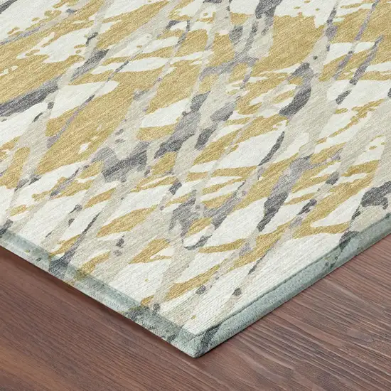 Gold And Ivory Abstract Washable Indoor Outdoor Area Rug Photo 7