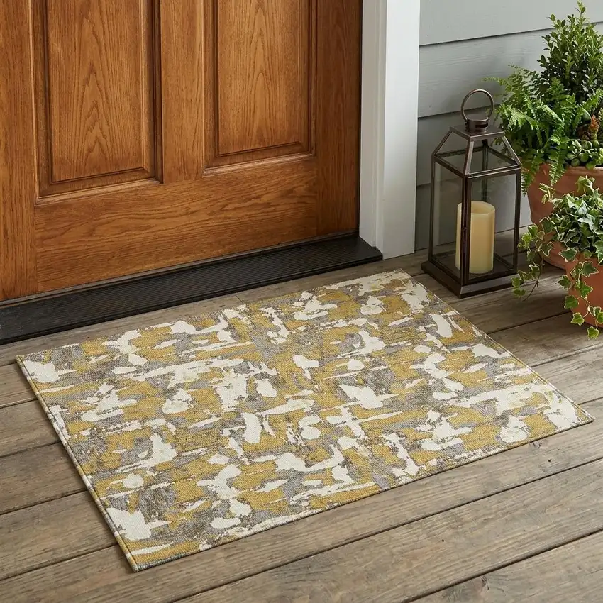Gold And Ivory Abstract Washable Indoor Outdoor Area Rug Photo 1
