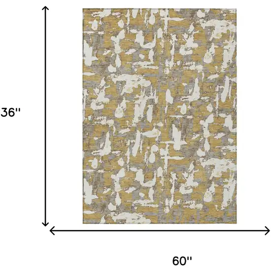 Gold And Ivory Abstract Washable Indoor Outdoor Area Rug Photo 9