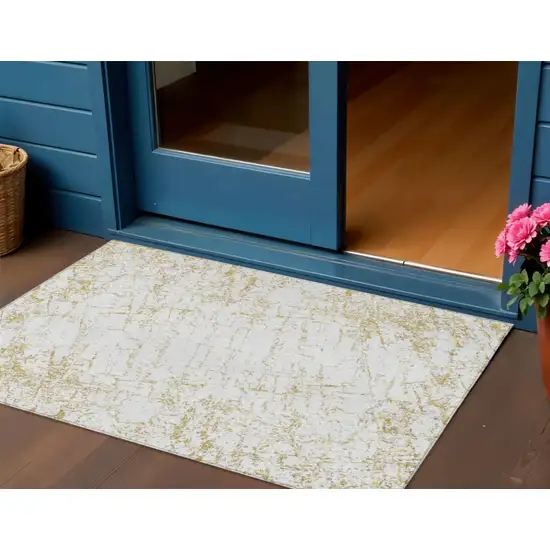 Gold And Ivory Abstract Washable Indoor Outdoor Area Rug Photo 1