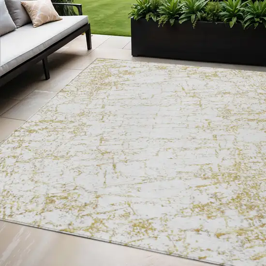 Gold And Ivory Abstract Washable Indoor Outdoor Area Rug Photo 1
