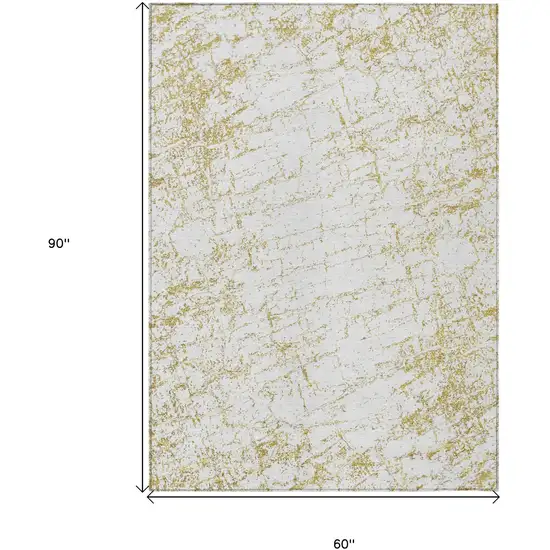 Gold And Ivory Abstract Washable Indoor Outdoor Area Rug Photo 3