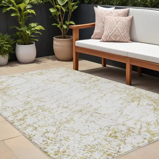 Gold And Ivory Abstract Washable Indoor Outdoor Area Rug Photo 1