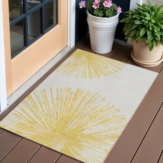 Gold And Ivory Abstract Washable Indoor Outdoor Area Rug Photo 1