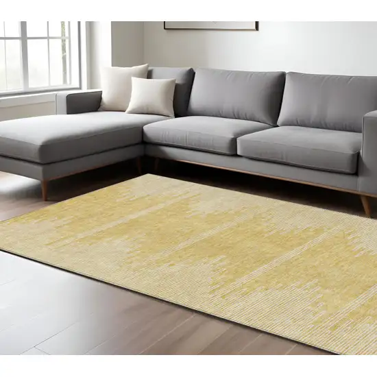 Gold And Ivory Abstract Washable Indoor Outdoor Area Rug Photo 9