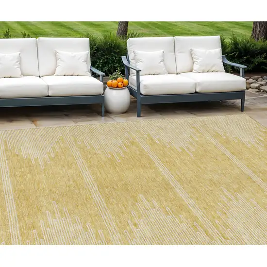 Gold And Ivory Abstract Washable Indoor Outdoor Area Rug Photo 1