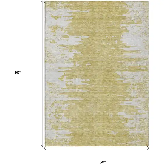 Gold And Ivory Abstract Washable Indoor Outdoor Area Rug Photo 3