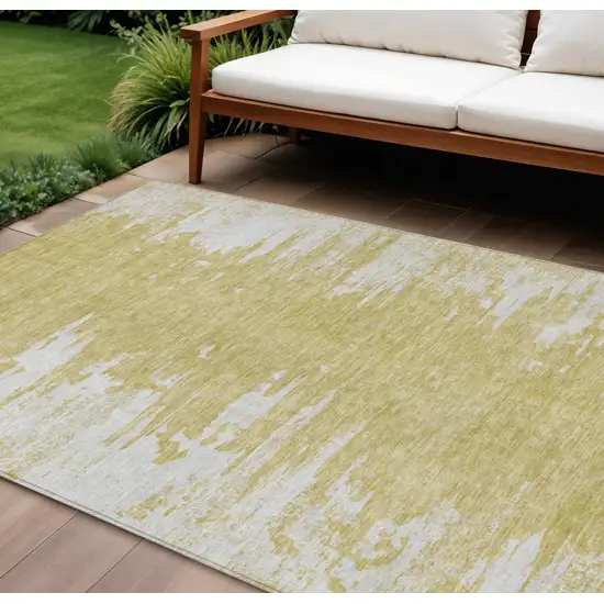 Gold And Ivory Abstract Washable Indoor Outdoor Area Rug Photo 1