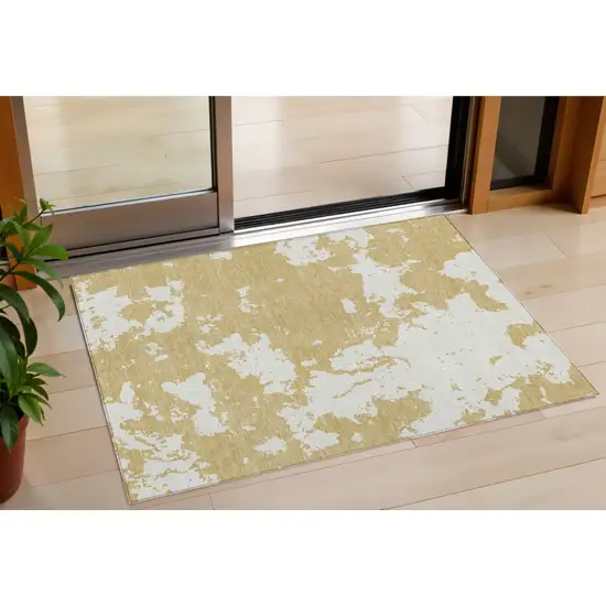 Gold And Ivory Abstract Washable Indoor Outdoor Area Rug Photo 1