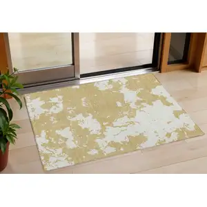 Photo of Gold And Ivory Abstract Washable Indoor Outdoor Area Rug