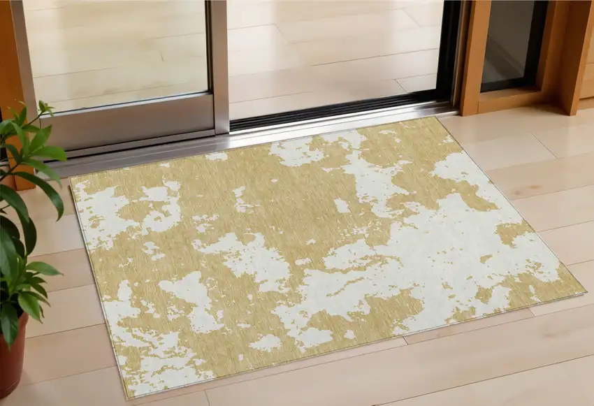 Gold And Ivory Abstract Washable Indoor Outdoor Area Rug Photo 1