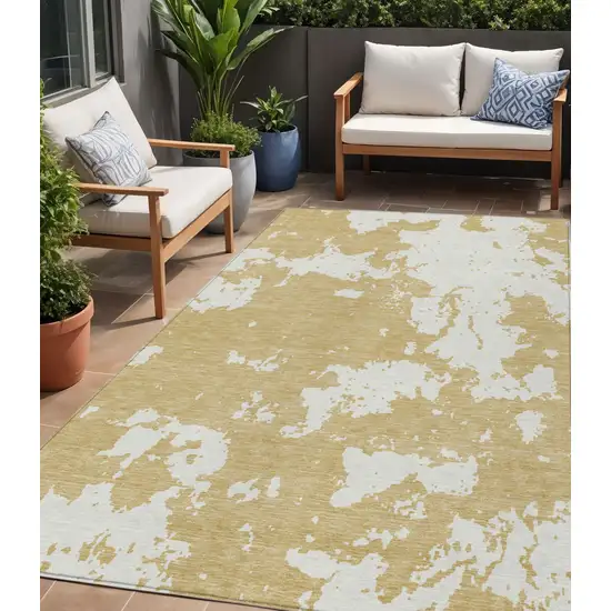 Gold And Ivory Abstract Washable Indoor Outdoor Area Rug Photo 1