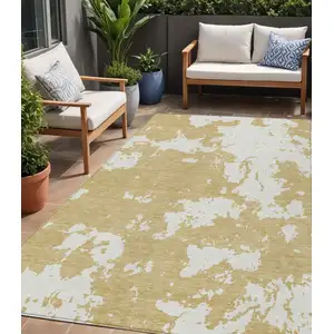 Photo of Gold And Ivory Abstract Washable Indoor Outdoor Area Rug