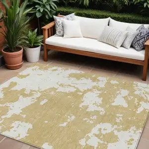 Photo of Gold And Ivory Abstract Washable Indoor Outdoor Area Rug
