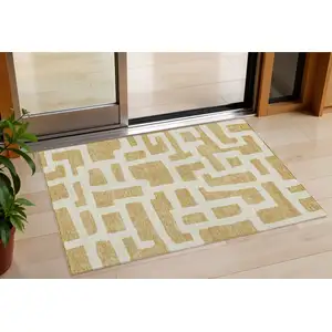 Photo of Gold And Ivory Abstract Washable Indoor Outdoor Area Rug