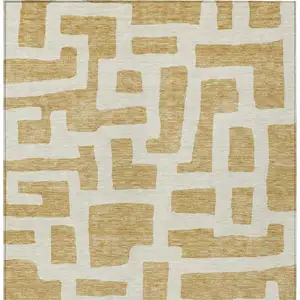 Photo of Gold And Ivory Abstract Washable Indoor Outdoor Area Rug
