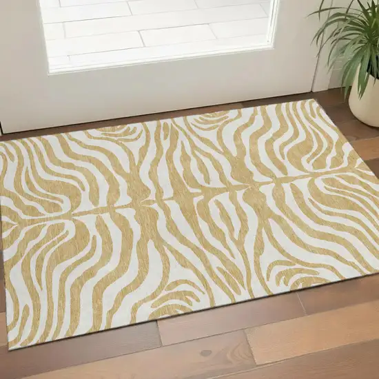 Gold And Ivory Animal Print Washable Area Rug With UV Protection Photo 1