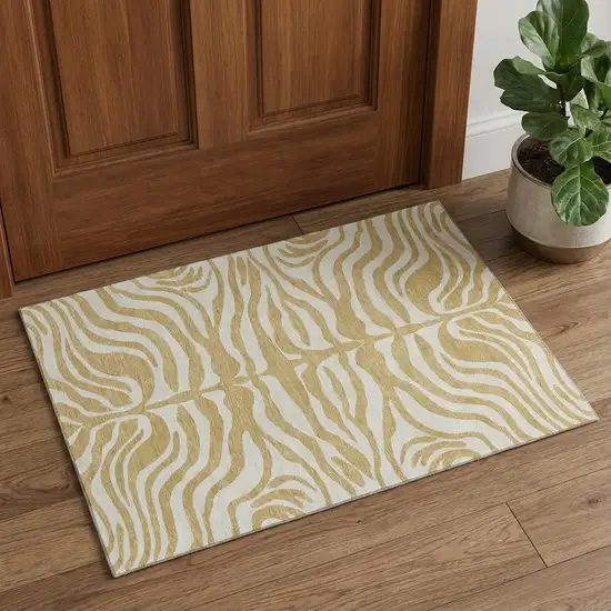 Gold And Ivory Animal Print Washable Area Rug With UV Protection Photo 1