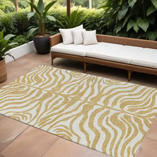 Gold And Ivory Animal Print Washable Indoor Outdoor Area Rug Photo 1