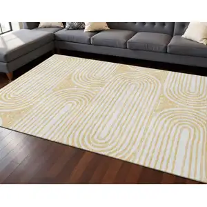 Photo of Gold And Ivory Geometric Washable Area Rug With UV Protection