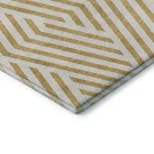 Photo of Gold And Ivory Geometric Washable Area Rug With UV Protection