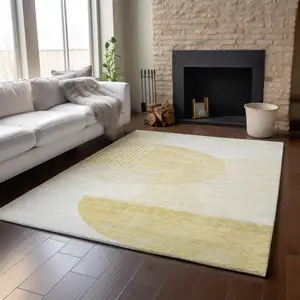 Photo of Gold And Ivory Geometric Washable Area Rug With UV Protection