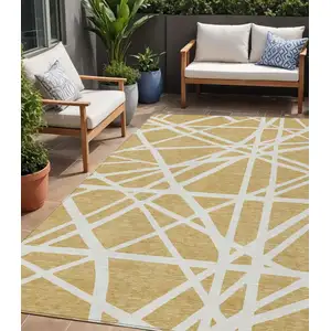 Photo of Gold And Ivory Geometric Washable Indoor Outdoor Area Rug