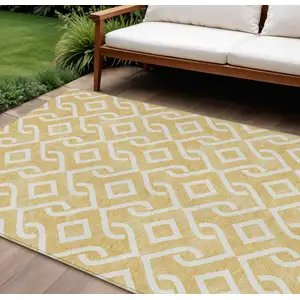 Photo of Gold And Ivory Geometric Washable Indoor Outdoor Area Rug