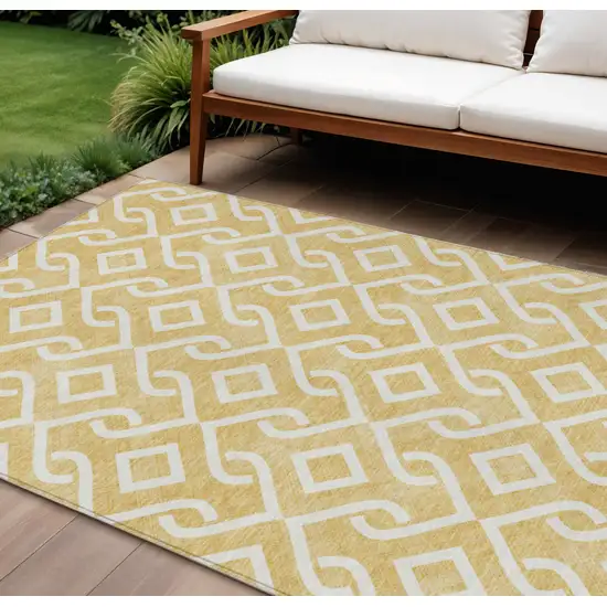 Gold And Ivory Geometric Washable Indoor Outdoor Area Rug Photo 1