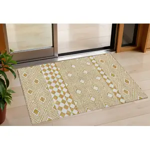 Photo of Gold And Ivory Geometric Washable Indoor Outdoor Area Rug