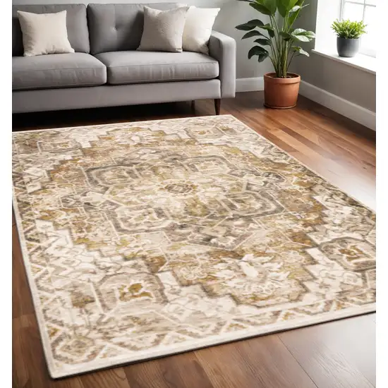 Gold And Ivory Oriental Power Loom Stain Resistant Area Rug With Fringe Photo 1