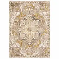 Photo of Gold And Ivory Oriental Power Loom Stain Resistant Area Rug With Fringe