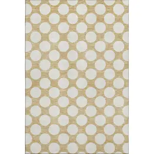 Photo of Gold And Ivory Polka Dot Washable Area Rug With UV Protection