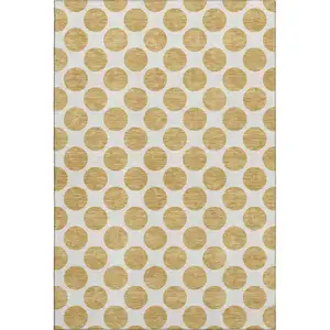 Photo of Gold And Ivory Polka Dot Washable Area Rug With UV Protection
