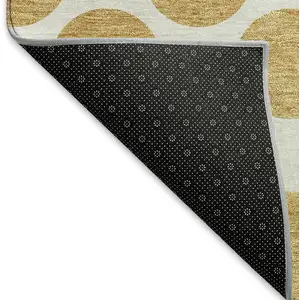 Photo of Gold And Ivory Polka Dot Washable Area Rug With UV Protection