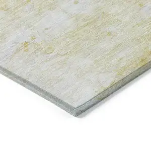 Photo of Gold Beige And Ivory Abstract Washable Indoor Outdoor Area Rug