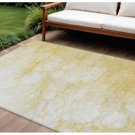 Gold Beige And Ivory Abstract Washable Indoor Outdoor Area Rug Photo 1