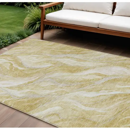 Gold Beige And Ivory Abstract Washable Indoor Outdoor Area Rug Photo 1